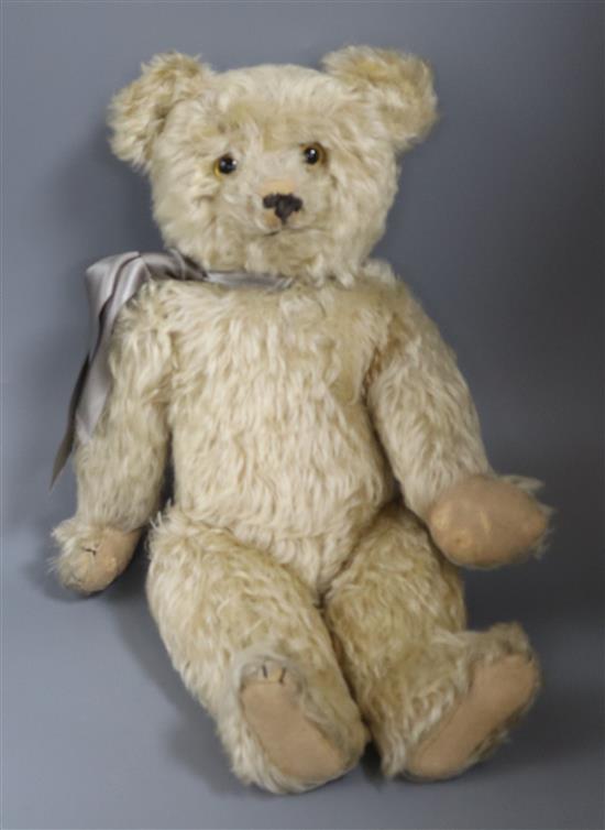 A 1920s English bear, with glass eyes, 19in., good mohair, original paw pads